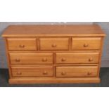 A pine chest of 3 over 4 drawers.