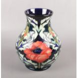A Contemporary Moorcroft pottery vase, in the 'poppy' pattern with impressed factory marks and '