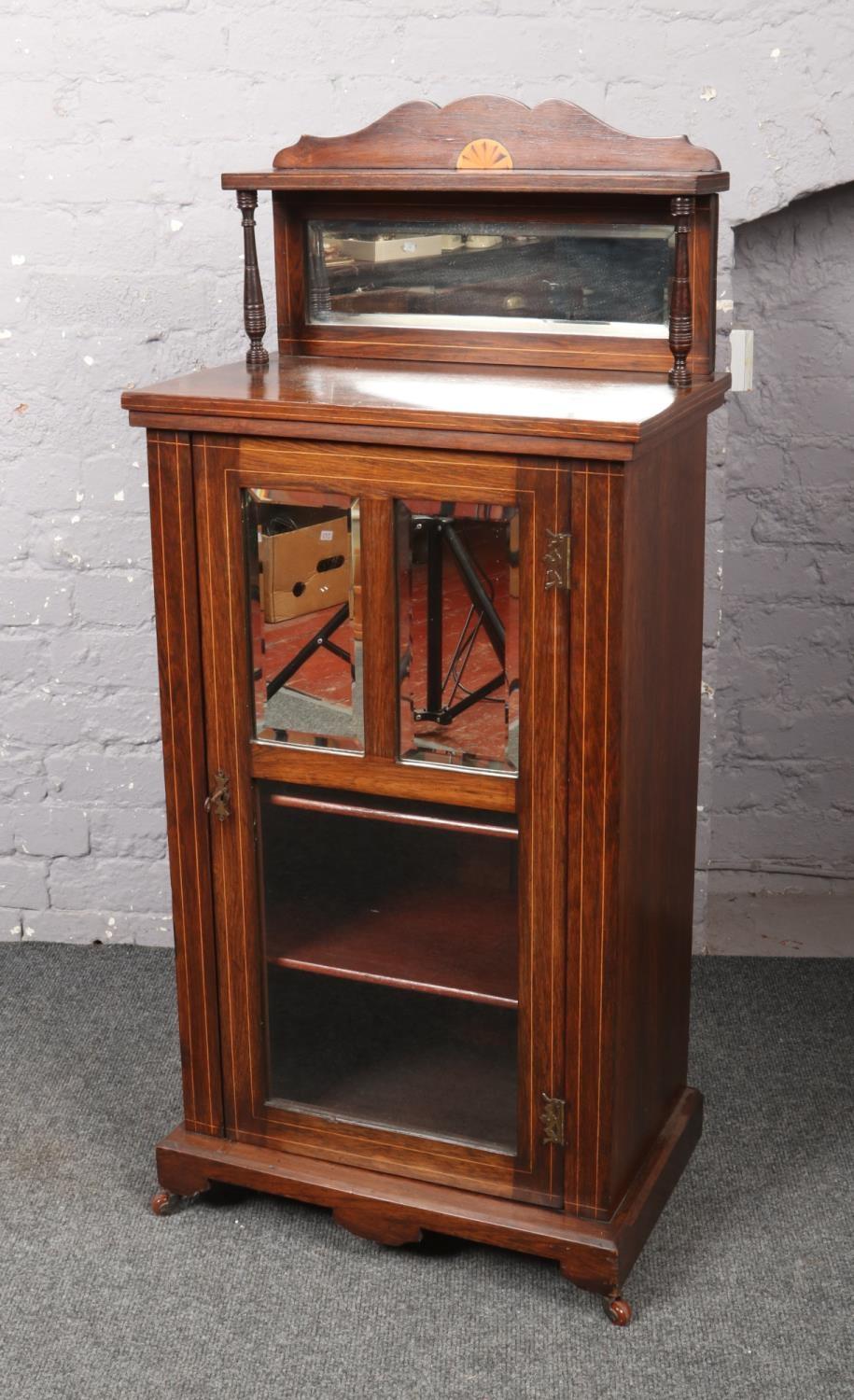 A rosewood mirror back cabinet. (Height 116cm, Width 55cm, Depth 35cm).
