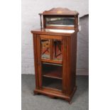 A rosewood mirror back cabinet. (Height 116cm, Width 55cm, Depth 35cm).