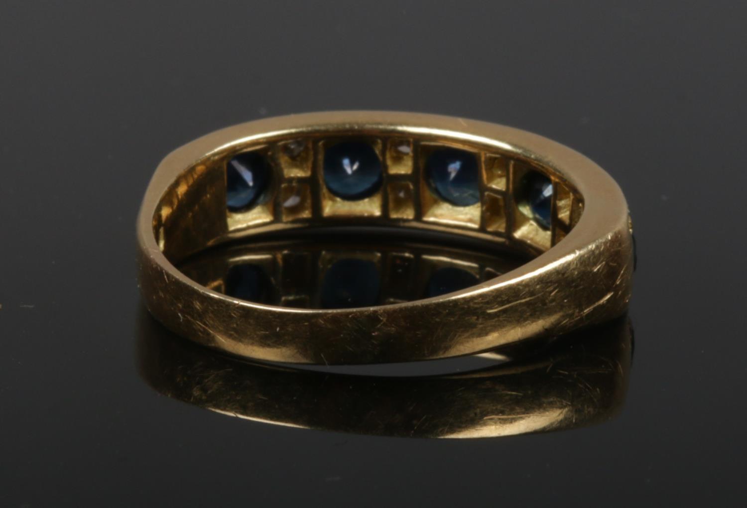 A gold, diamond and sapphire ring. Set with five sapphires interspersed with four pairs of diamonds. - Image 2 of 2