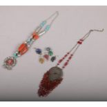 A quantity of vintage jewellery to include silver and hardstone pendants etc.