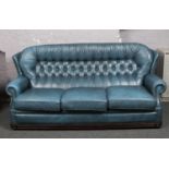 A blue leather Chesterfield high back settee, 184cm.