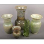 Four pear tree pottery vases along with a green art glass vase.