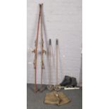 A pair of vintage leather lederhosen, pair of Komperdell skiis with poles and a pair of Fagan ice