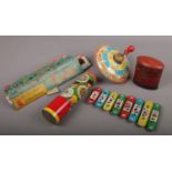 A vintage toy tinplate spinning top, xylophone and kaleidoscope, a George V Post Office money bank