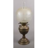 A Late 19th Century Oil Lamp by Veritas Lamp Works Co with brass reservoir & glass shade