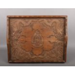 An Anglo-Chinese wooden tray, carved with dragons, and bamboo, bearing the Victorian badge of the