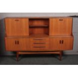 A large G-plan teak sideboard with sliding door and drawer base.