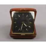 A Junghans folding travelling bedside alarm clock. With black dial and gilt baton markers, 6cm