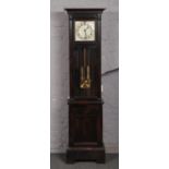 A George V oak cased 8 day longcase clock. With silvered square dial having Arabic numeral