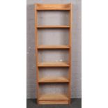 A large pine open shelving unit along with a pine bookcase.