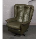 A retro G-Plan style leather swivel easy chair.