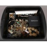 A tray of mixed costume jewellery including a DKNY bangle, cufflinks and necklets etc.