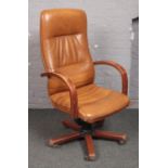 A tanned leather swivel office arm chair.