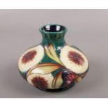 A Moorcroft vase, of flattened circular form, tube lined in the Albany pattern designed by Nicola