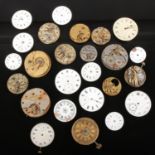 A box of mixed pocket watch movements and dials for spares or repair.