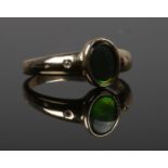 A 14ct gold, ammolite and diamond ring by Korite International, Canada. With oval ammolite panel