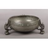 An Arts & Crafts planished pewter bowl. Raised on three supports formed as liver birds, 22cm