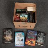 A box of Clive Cussler books.