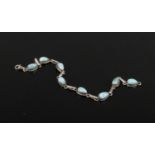 A silver and larimar line bracelet, 19cm.