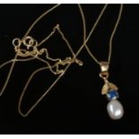 A 9ct gold freshwater pearl and blue stone pendant on trace chain.