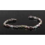 A silver multi gem line bracelet set with ovoid faceted gems, 19.25cm.