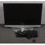 A Samsung 32 inch television with remote along with a DVD player.