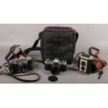 A Canon AE-1 slr camera with Canon 50mm lens, a Praktica L2 slr camera and Gorlitz lens and a
