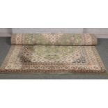 A Green patterned ground rug approx 180 cm x 267 cm