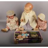 Three 1960s dolls and a vintage boxed Walt Disney movie viewer.