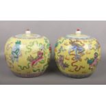 A pair of 20th century Chinese yellow ground jars and covers. Painted in coloured enamels with