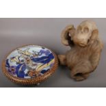A Bursley ware tube lined dish decorated with flowers and a carved wooden statue of a monkey.