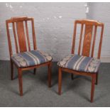 A pair of G Plan oak slat back dining chairs.