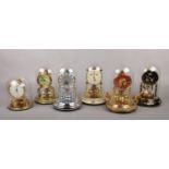 Six West German torsion clocks, five under glass domes and one plastic. Including Kundo, Schatz,