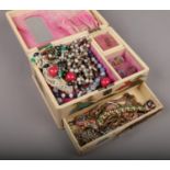 An oriental jewellery box and contents of costume jewellery, to include white metal chains, gilt and