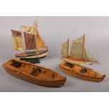 Four detailed model boats. Two sail boats and two rowing boats. Tallest 22.5cm.