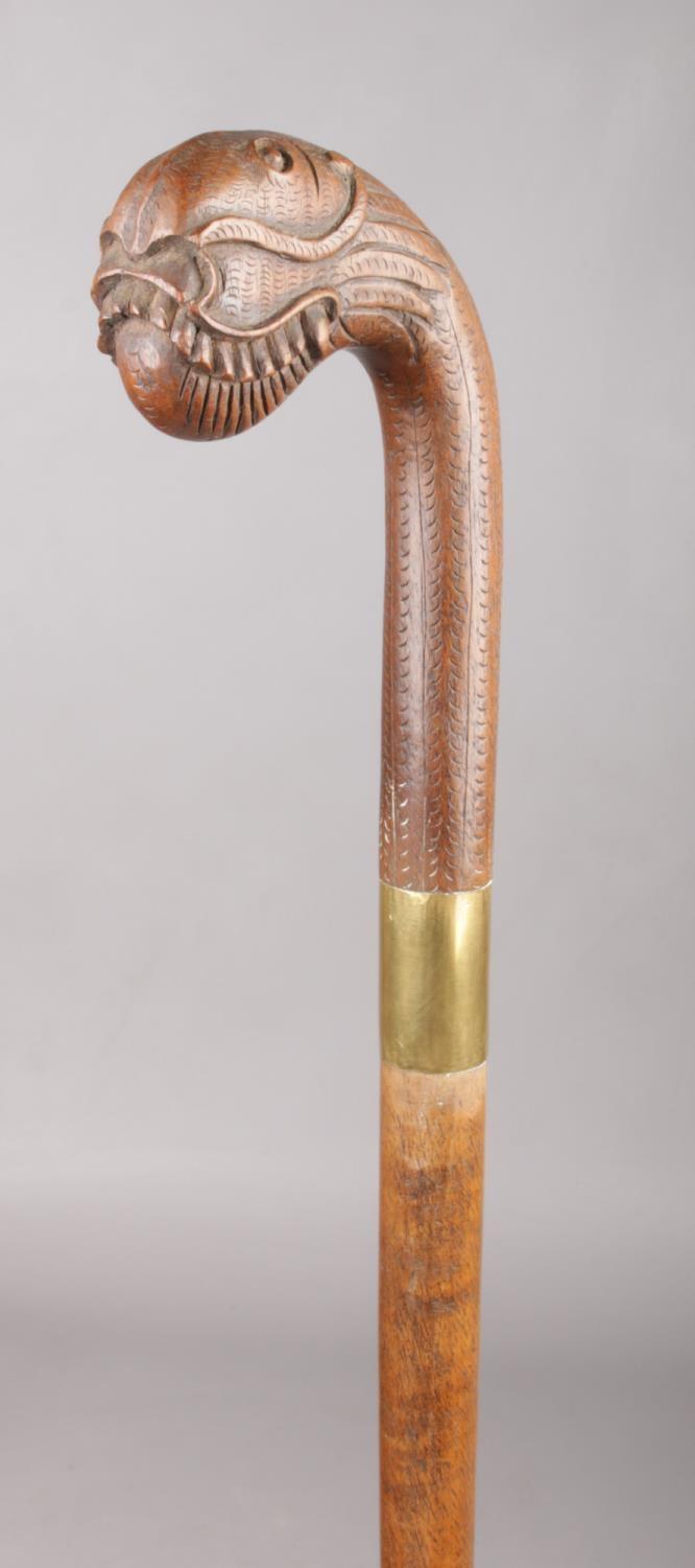 A walking stick with brass collar and Oriental carved hardwood terminal formed as a dragon, possibly - Image 2 of 2