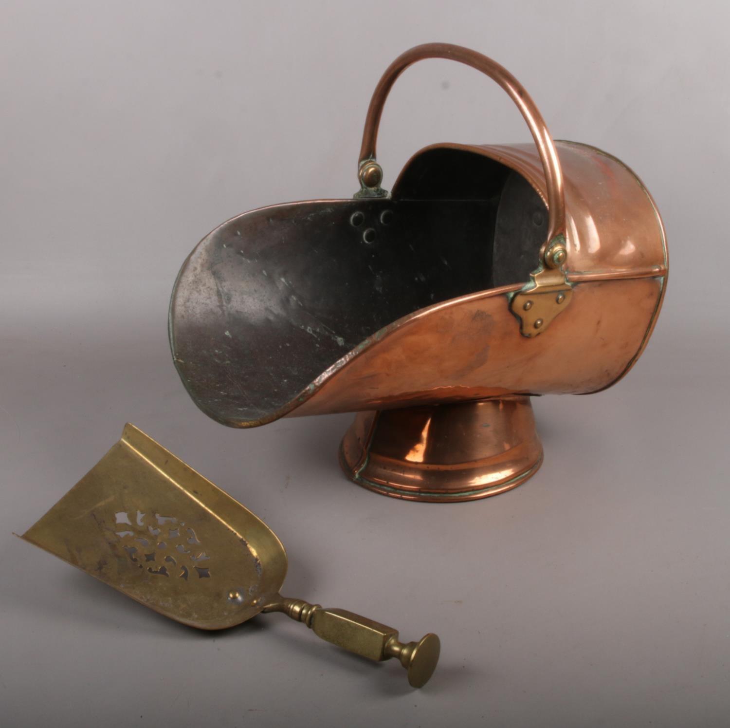 A Copper Coal Scuttle with brass shovel.