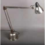 A chrome angle poise lamp.