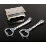 A silver plate gentleman's stud box along with two silver handled bottle openers.