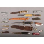 A box of assorted knives including a Swiss army multi tool knife, Taylor of Sheffield hunting knife,