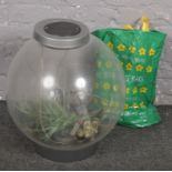 A bio orb fish tank, synthetic aquatic weeds and collection of tank gravel.