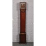 An Art Deco oak cased Grandmother clock. Housing a Garrard movement with platform escapement and