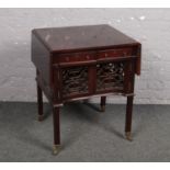 A George V mahogany sofa table. With cupboard section, ornamented with open fret carving and