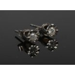 A pair of silver diamond set ear studs.