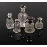 Five silver mounted cut glass scent bottles including one tortoiseshell example. All silver with