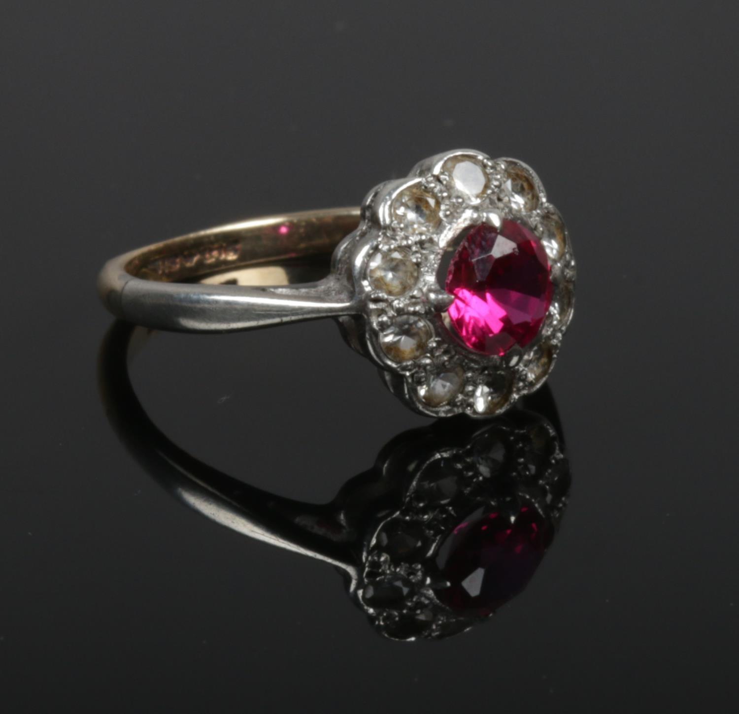 A 9ct gold and silver cluster ring set with pink and white paste stones. Size N.