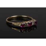 An 18ct gold, diamond and pink paste ring set on a scrollwork shank. Unmarked but tested. Size P.