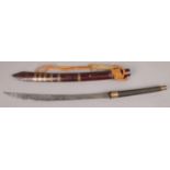 An oriental short sword with curved blade and wooden scabbard with brass mounts.